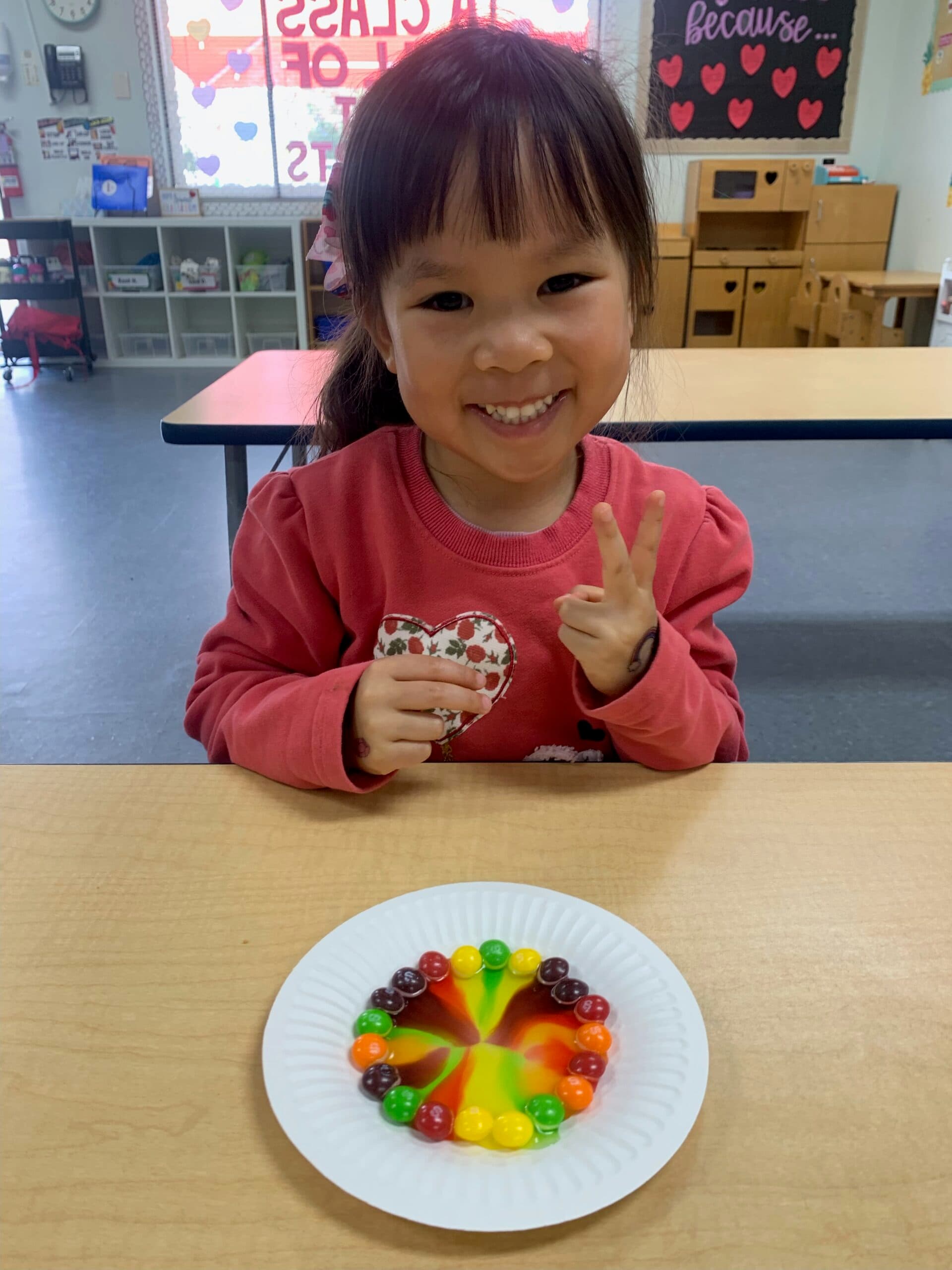 Student proudly showing off a finished art project