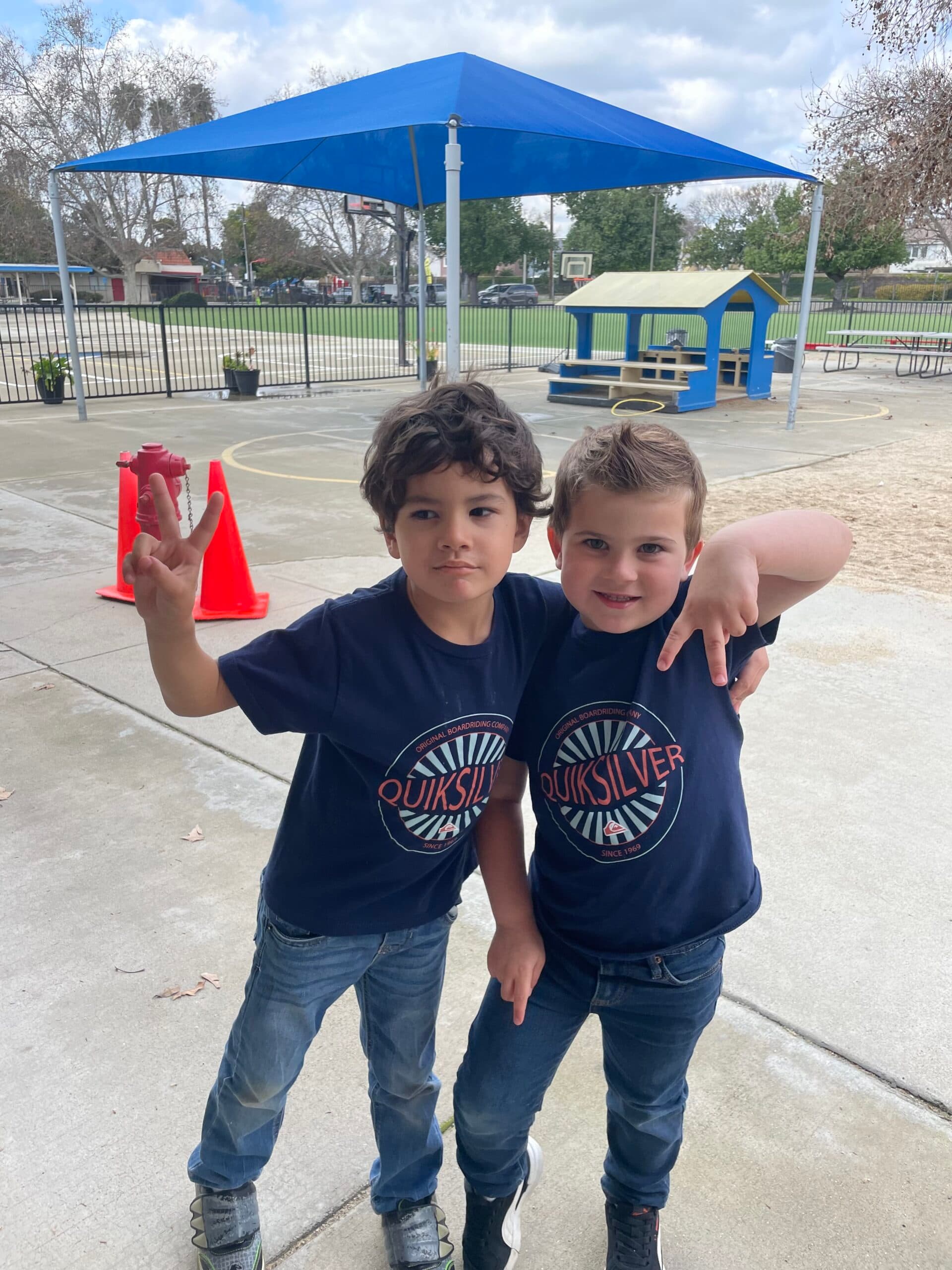 Two students posing together during outdoor play