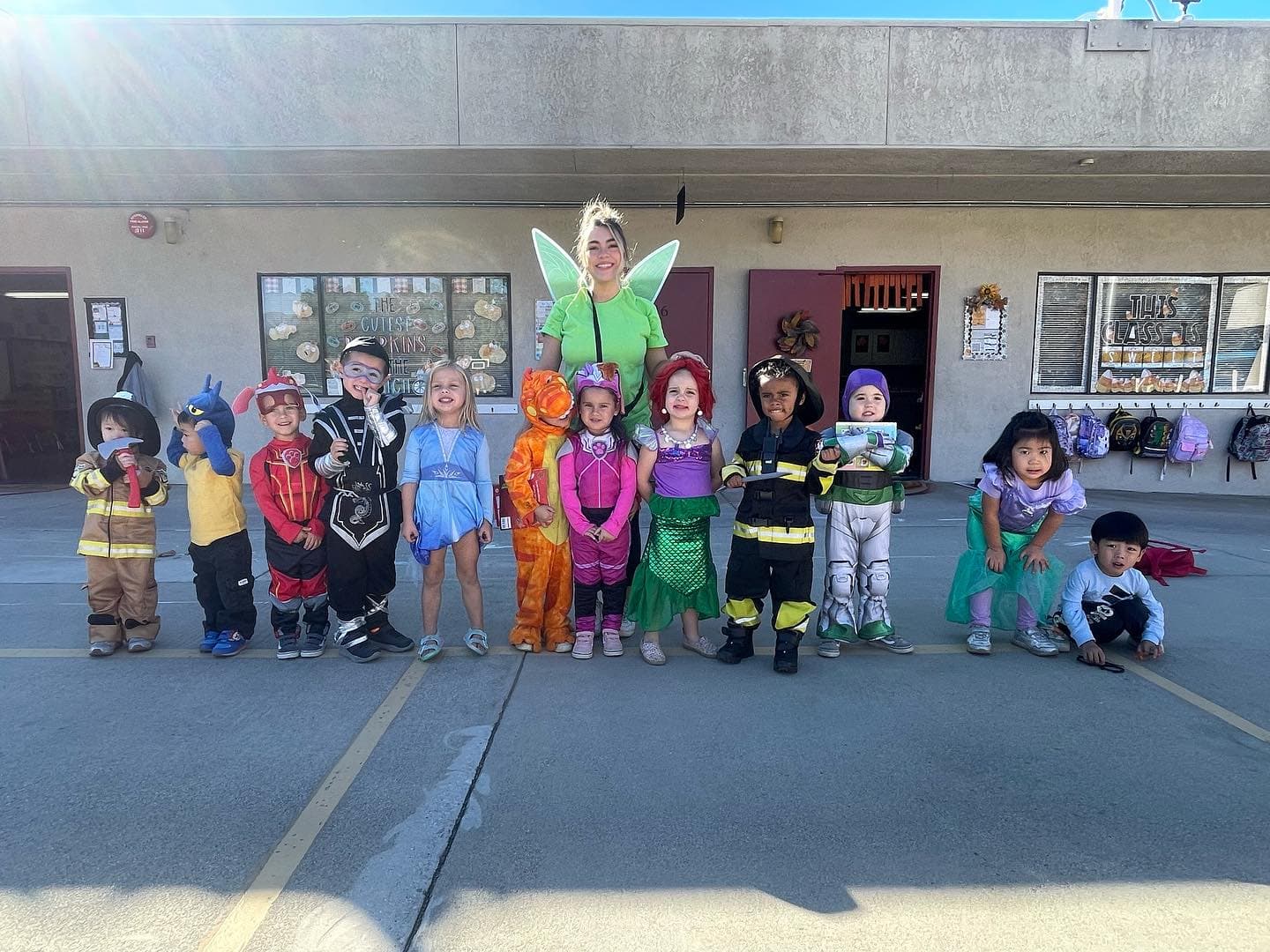 Students in playful costumes celebrating a classroom event