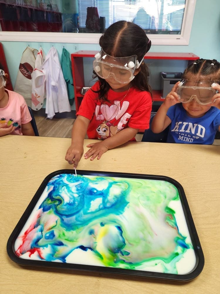 Pre-K student practicing stamp printing