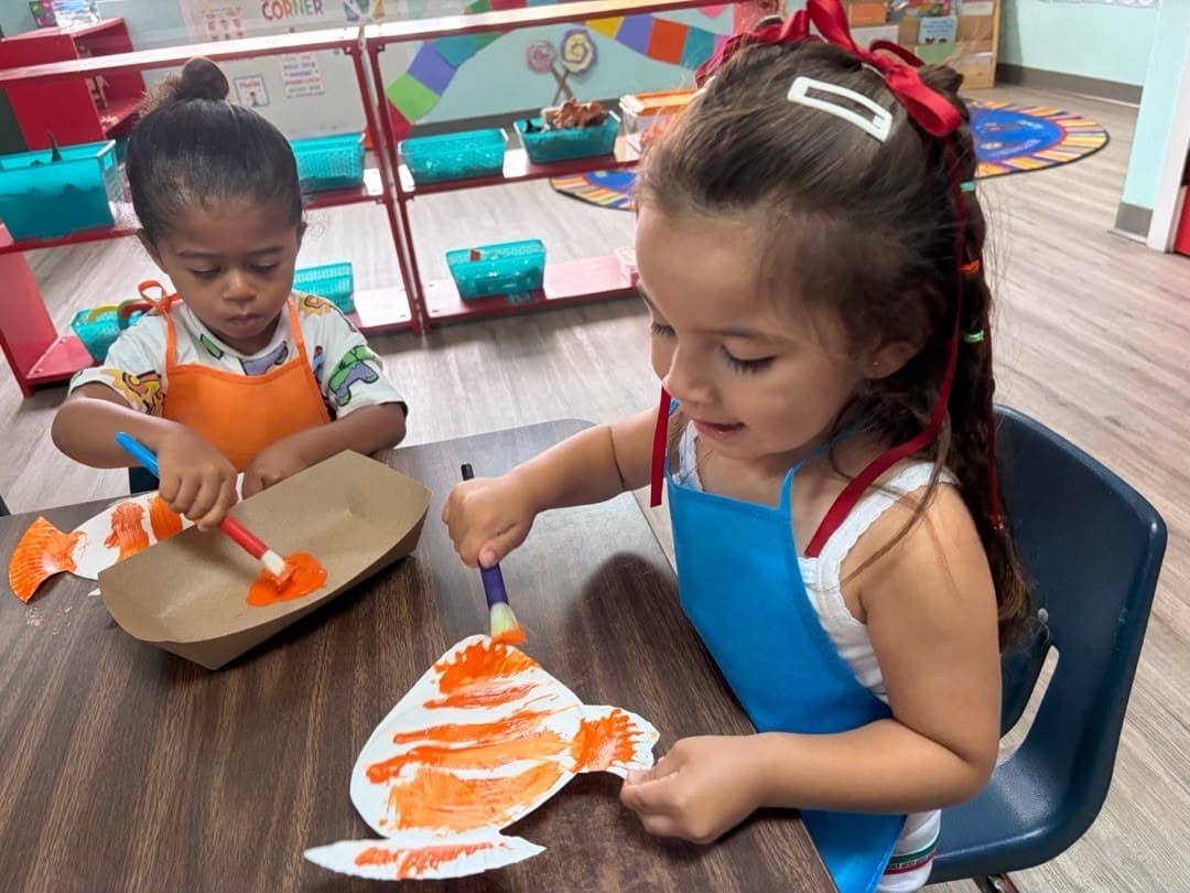 Preschoolers painting a fish art project