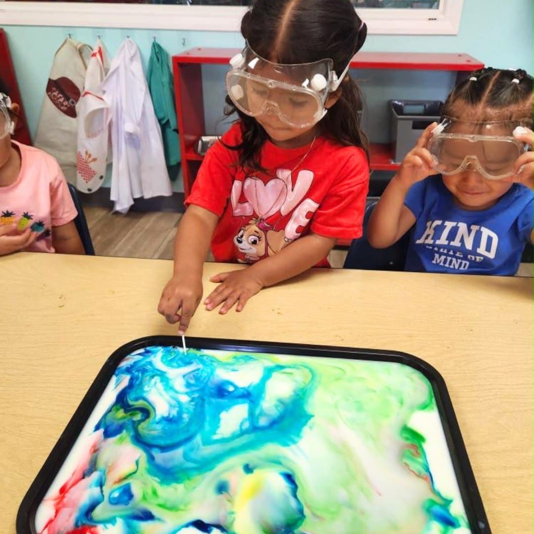 A staff member caring for a student at Little Explorers Academy